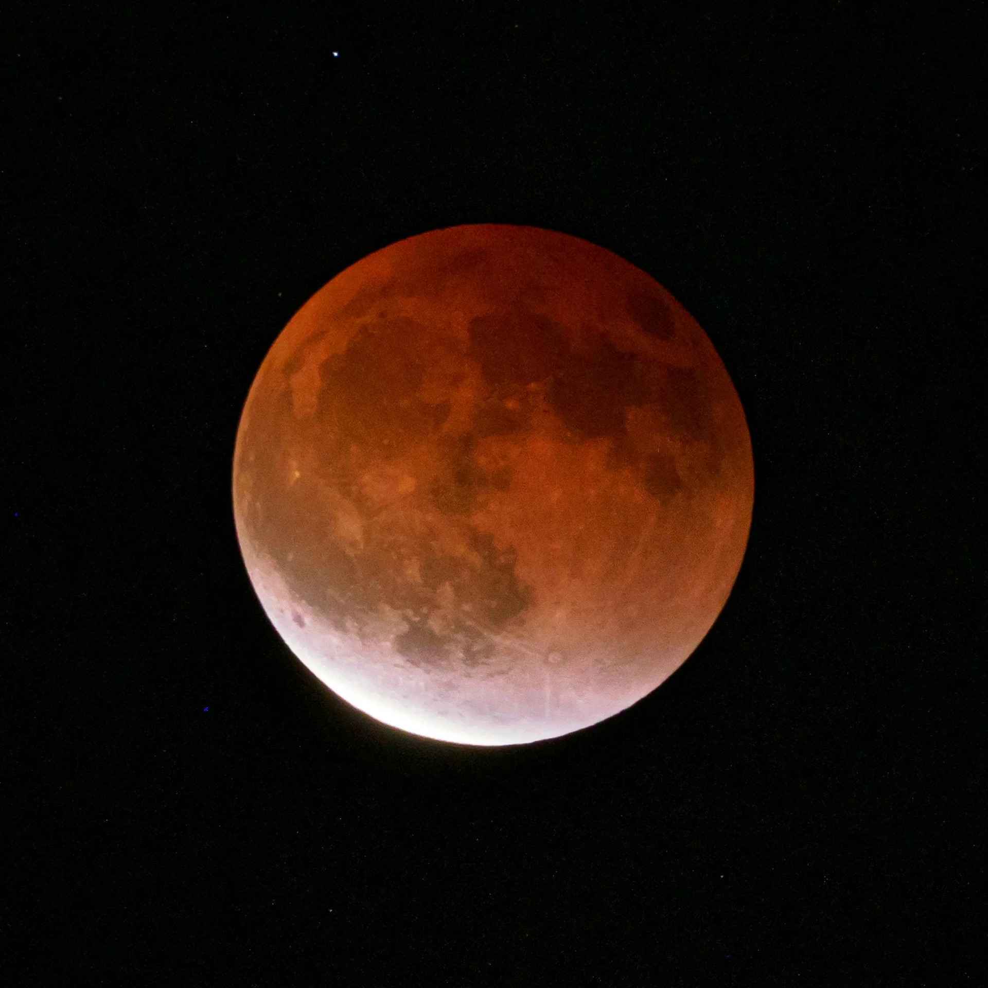 the earth's moon is shown over dark skies