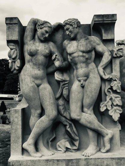 black and white po of three cherubs on a pedestal
