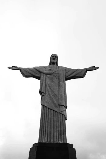 the statue of christ has one arm open in the air
