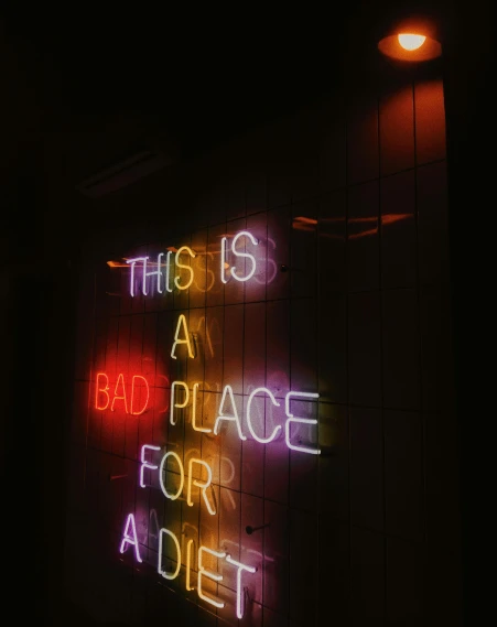 a sign with lights on sitting in a room