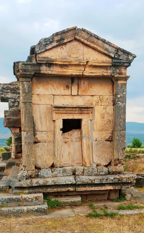 a very old building sitting out in the wild