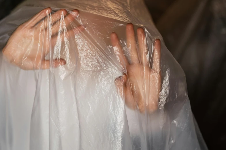 hand holding a plastic bag in between both hands