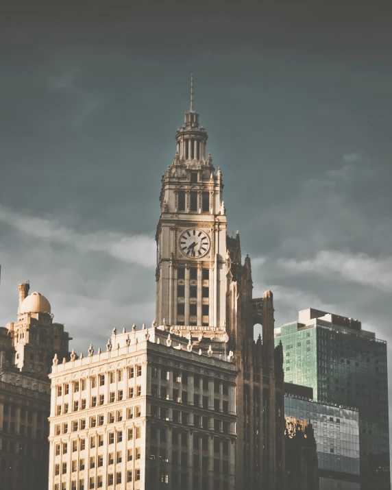 clock tower on top of tall building next to buildings