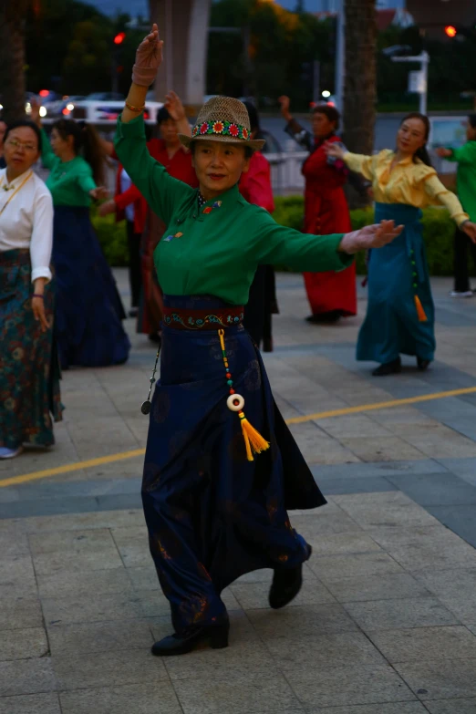 women wearing traditional costumes dance in a square