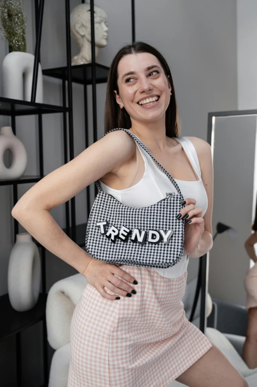 a woman posing in front of a mirror with her hand on the hips