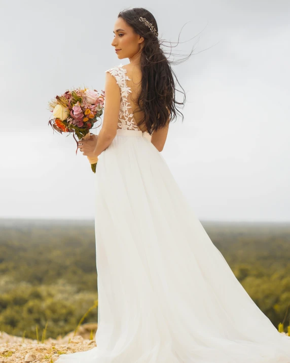 a woman in a wedding dress looking away