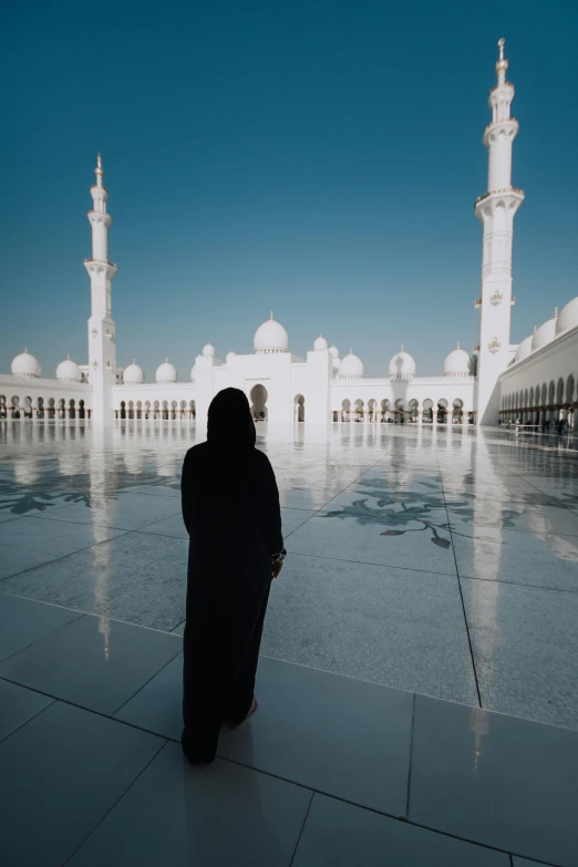 a woman is sitting in front of a building