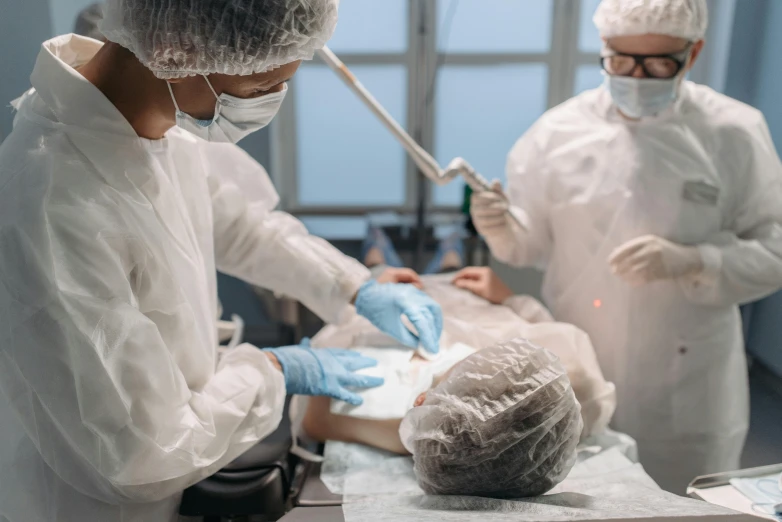an image of two surgeons operating a piece of 