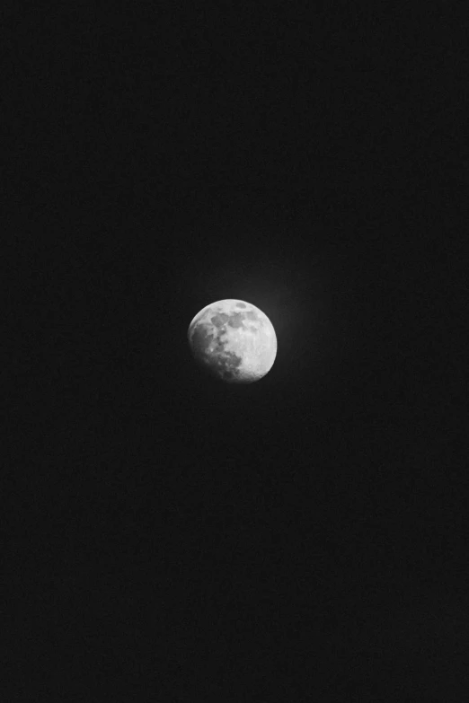 the moon seen through the dark night sky