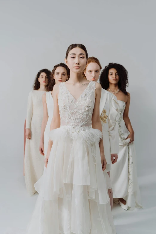 an image of people in wedding dresses standing together