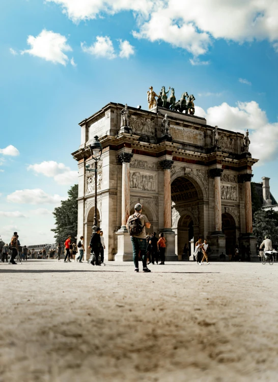 two men are walking toward an old stone structure