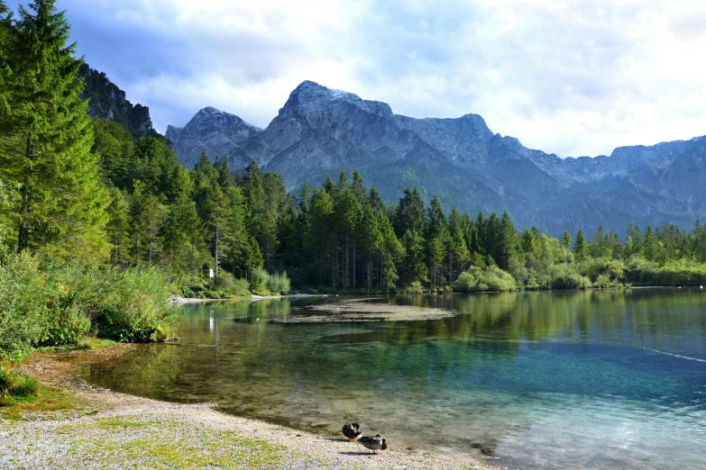 some mountains by the water with people on it