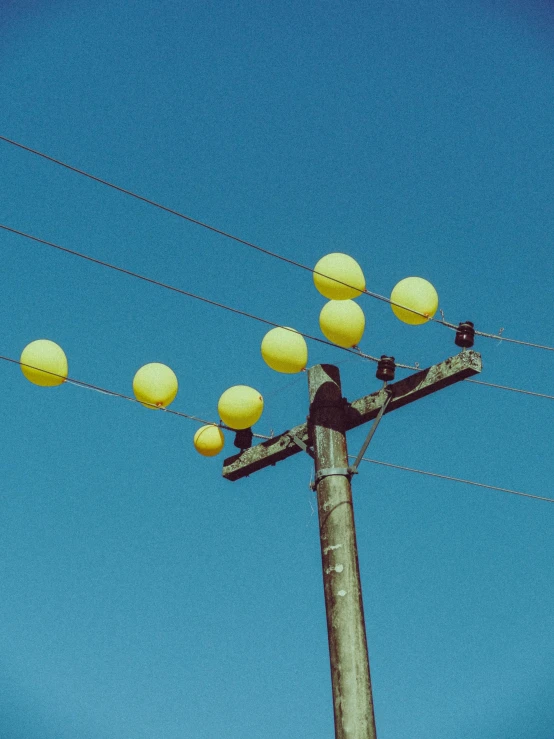 there are yellow lanterns hanging off the power lines