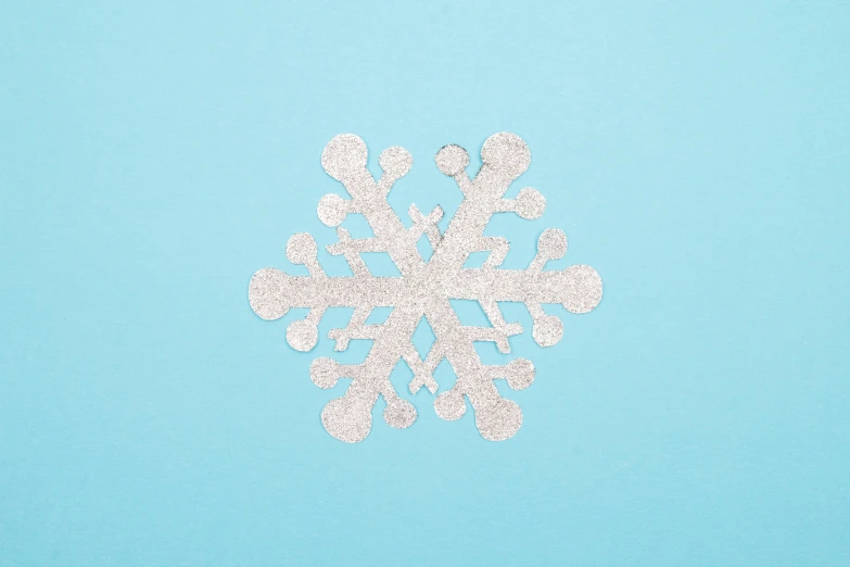 a snowflake is cut out on a light blue background