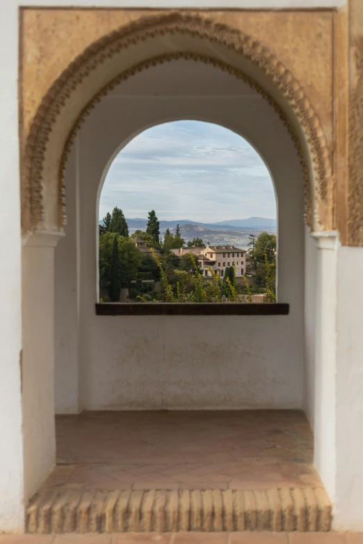 looking out through an archway at a scenic village in the distance