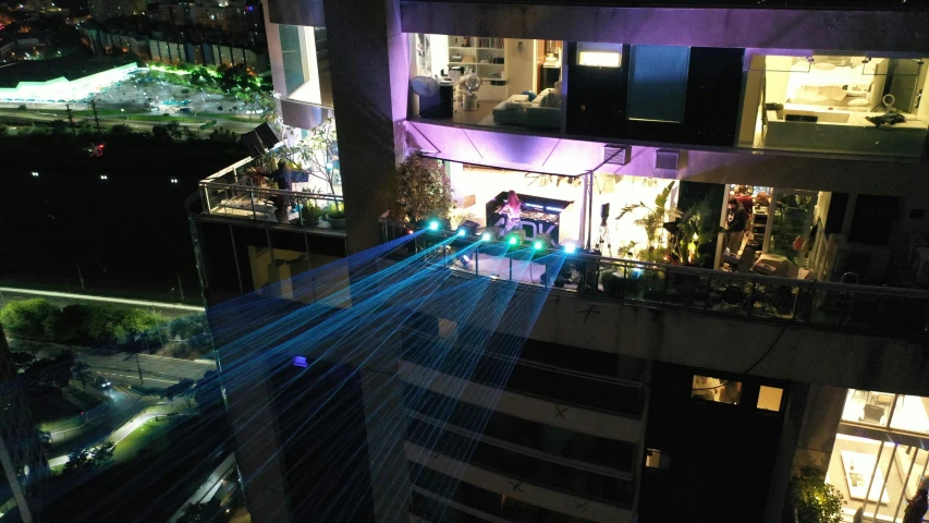 a building with traffic going down a busy road at night