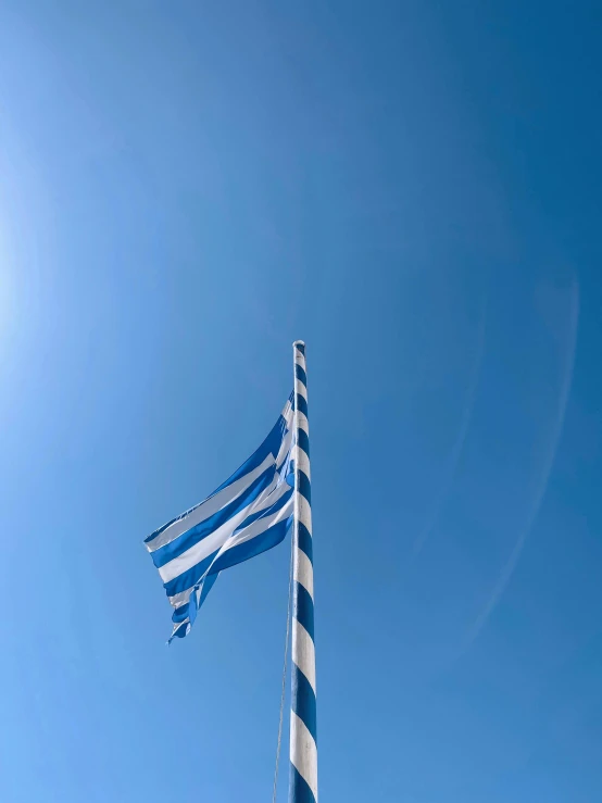 blue and white flags sticking in the sky