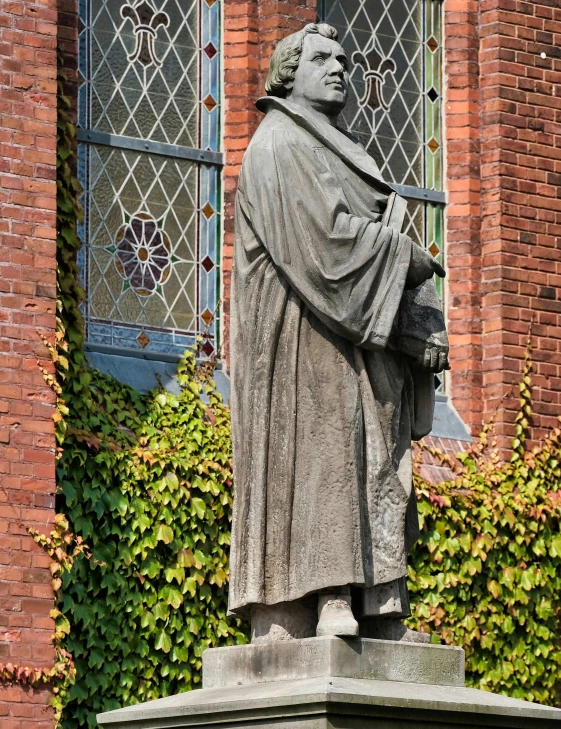 a statue is shown in front of a window