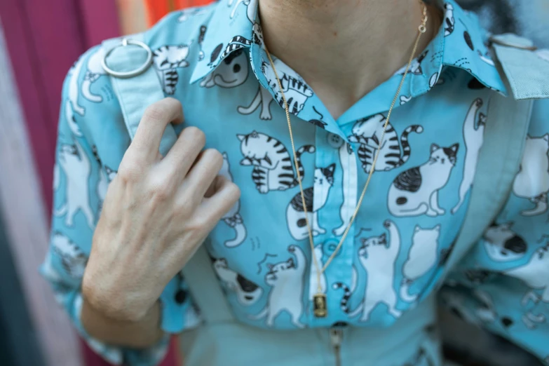 a man with glasses and a shirt on is adjusting his collar