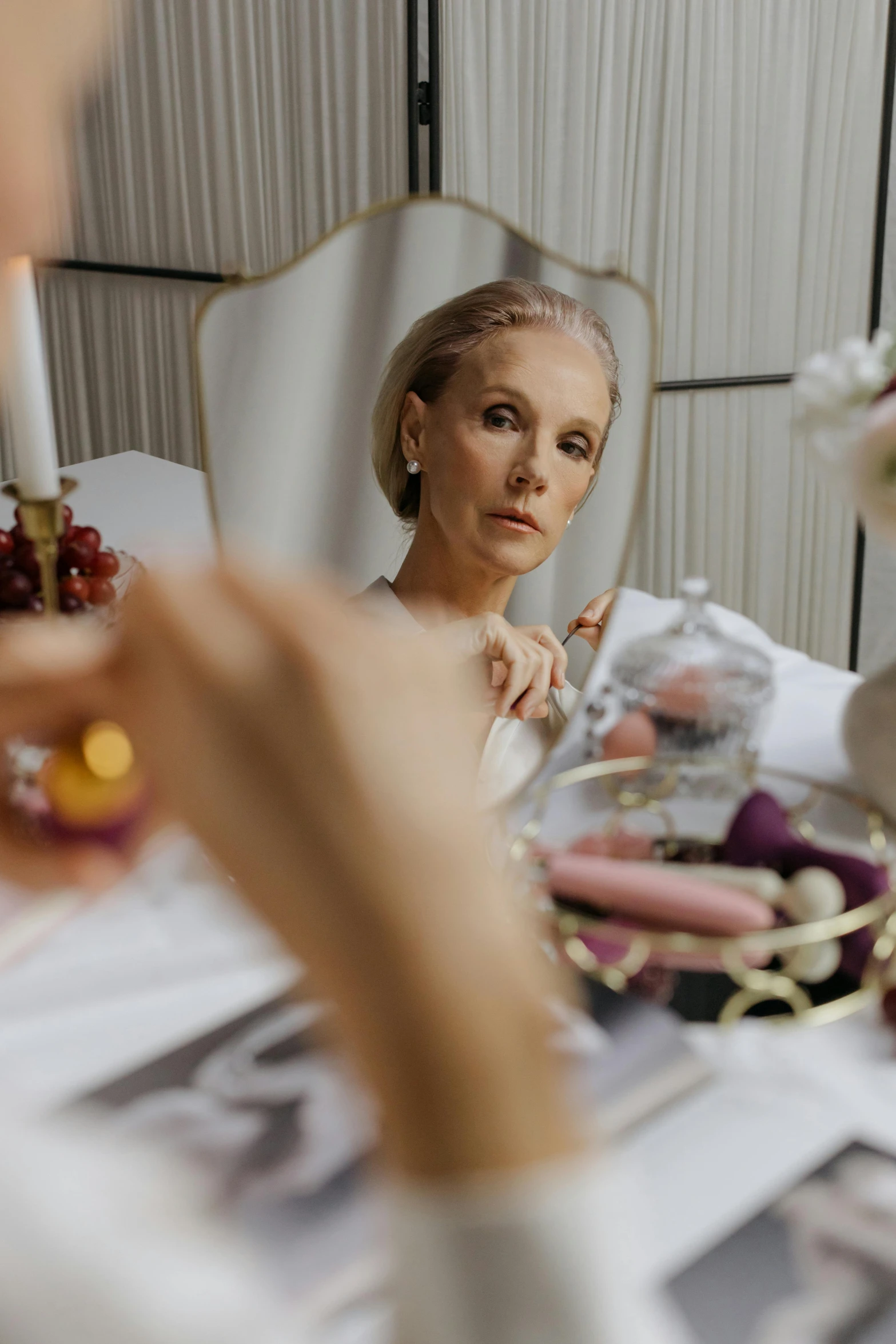 a woman is sitting at the table in a white dress