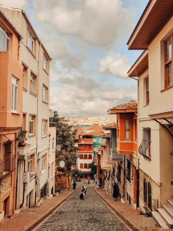 a cobblestone street with lots of people and buildings