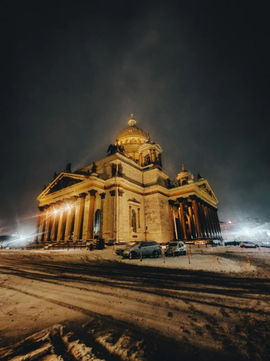 a large building with a large golden dome at night