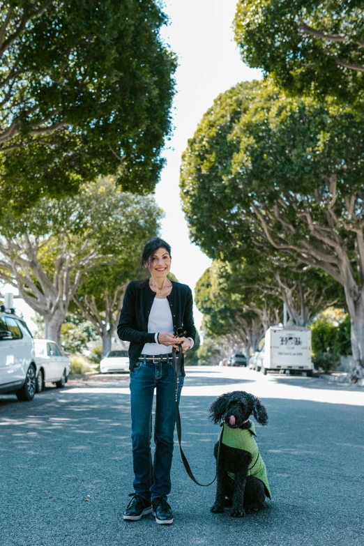 a woman walking two dogs on a street