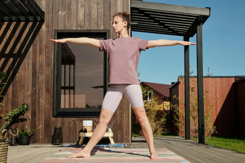 a woman standing on her arms out with a towel in front of her