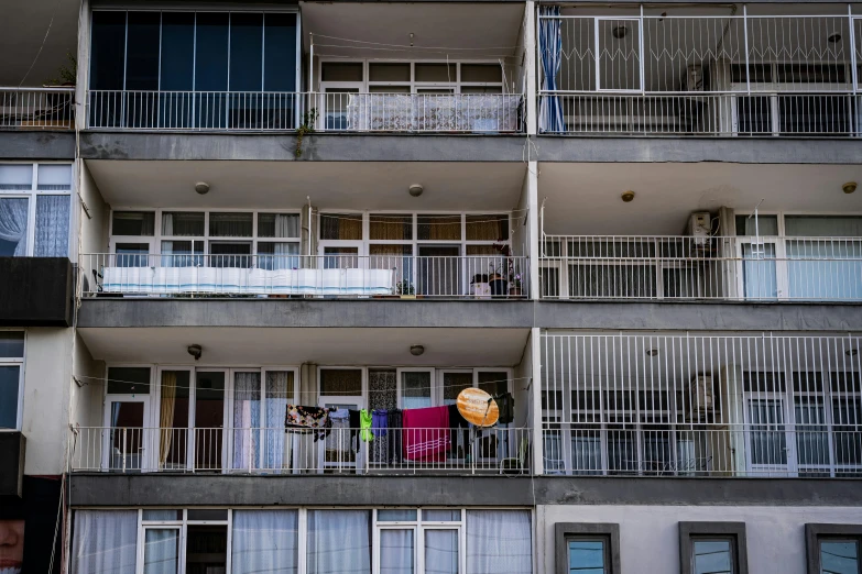 a building that has balconies and two different floors