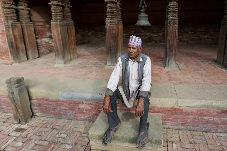 a man is sitting on the stone step