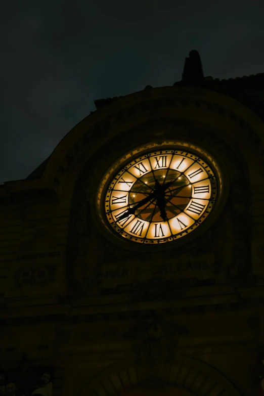 a large clock sitting on the side of a tall building