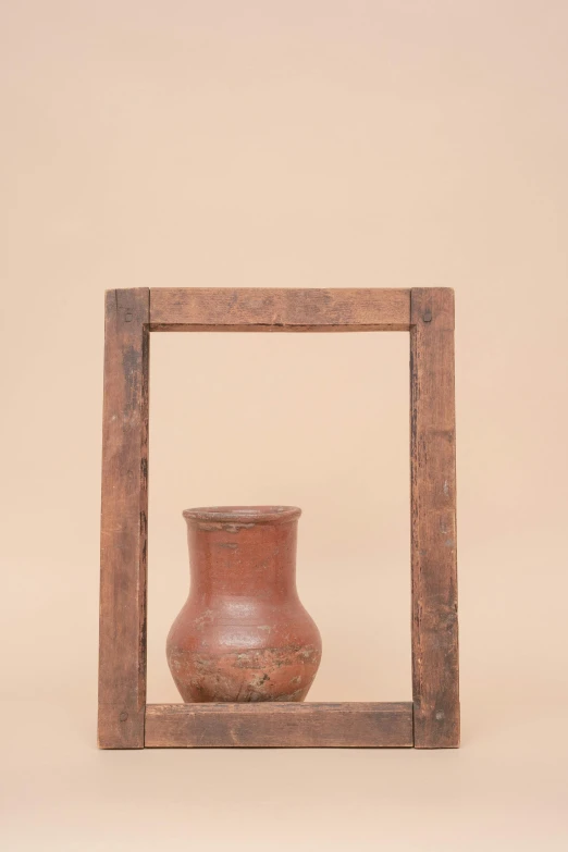 an old vase is in a wooden frame