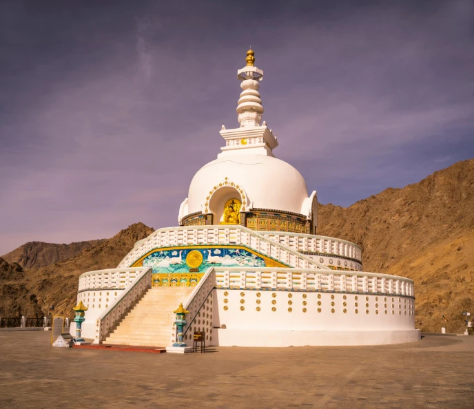 a large white building with a domed white and yellow top