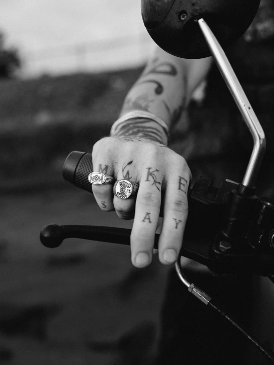 a black and white po of someone wearing a band with the word pray written on their hand