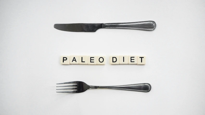 the word palediet spelled out of scrabble type letters with two forks