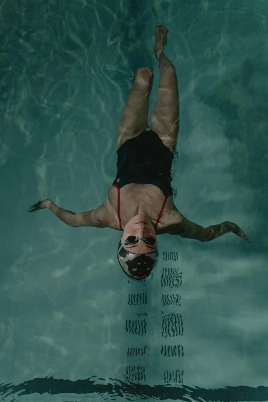 a man diving into the blue pool