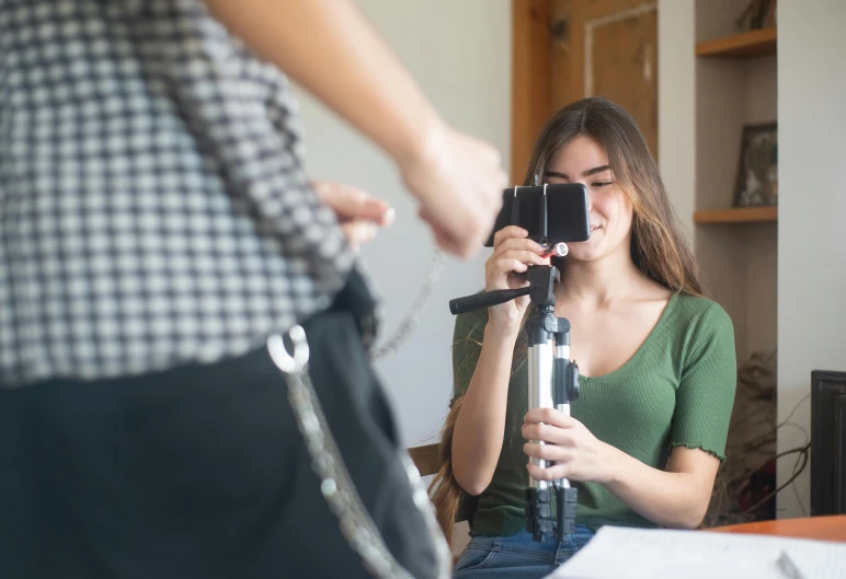 a woman taking a po of a camera