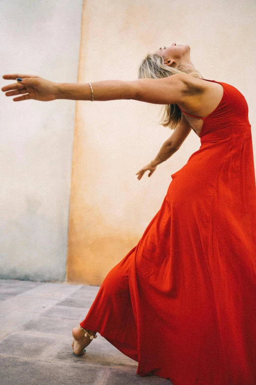 a beautiful woman in a long dress is dancing
