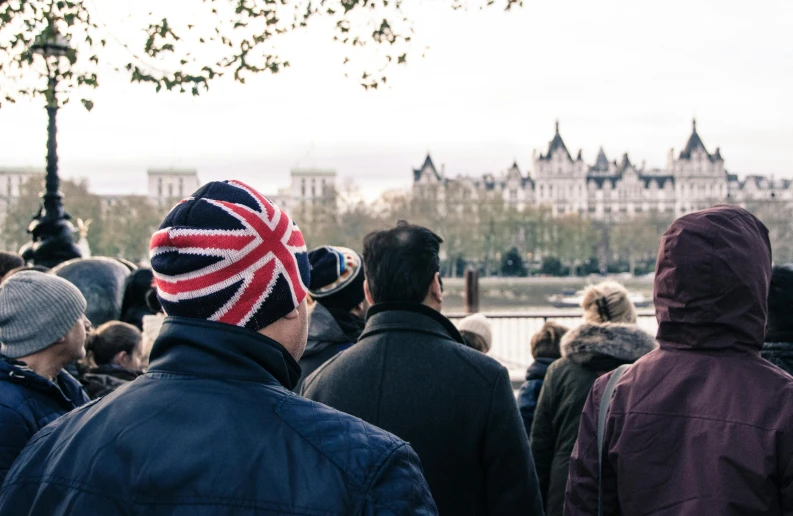 a large crowd of people standing in front of a palace