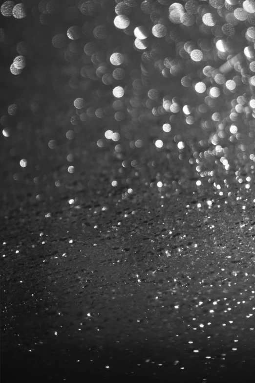 a black and white pograph with many small drops of water