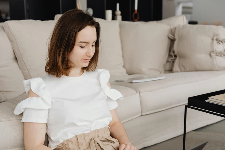 a woman in white blouse playing piano at home