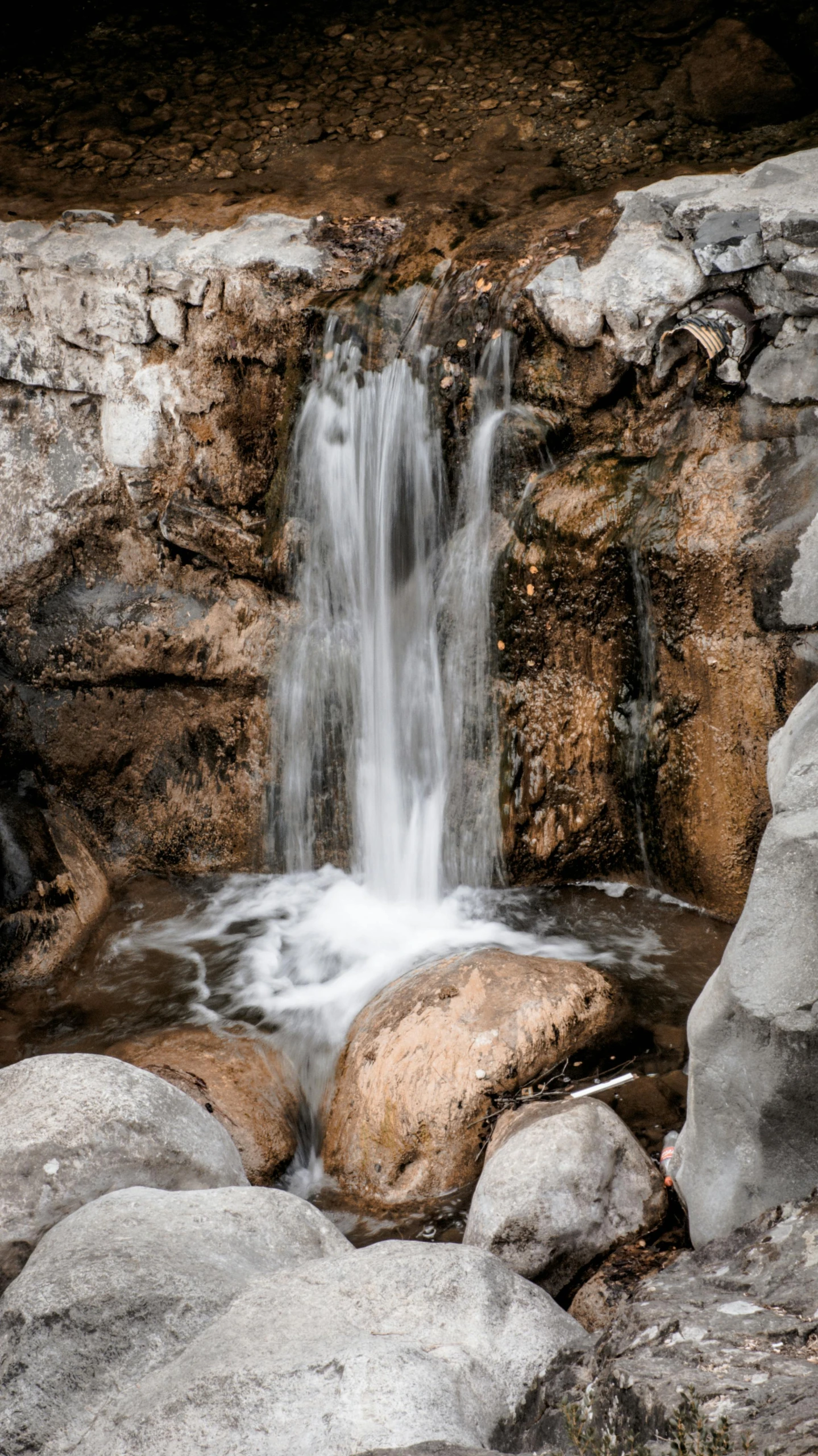 a waterfall that is going up a cliff