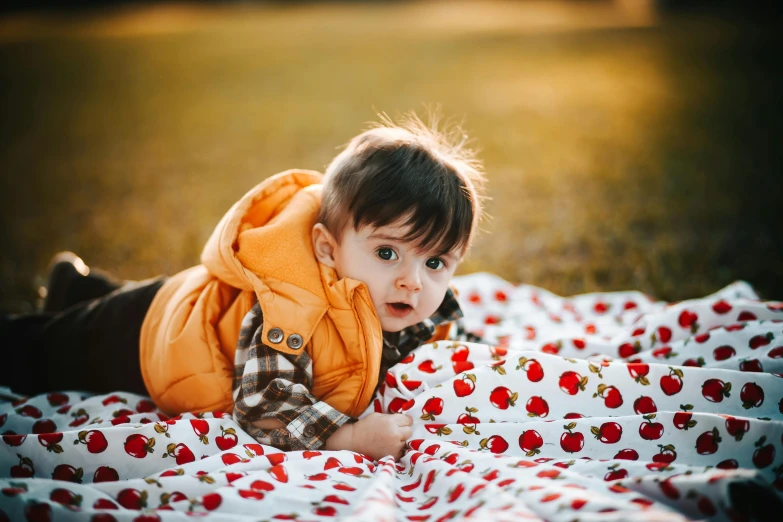 little girl sitting on blanket with mouth open