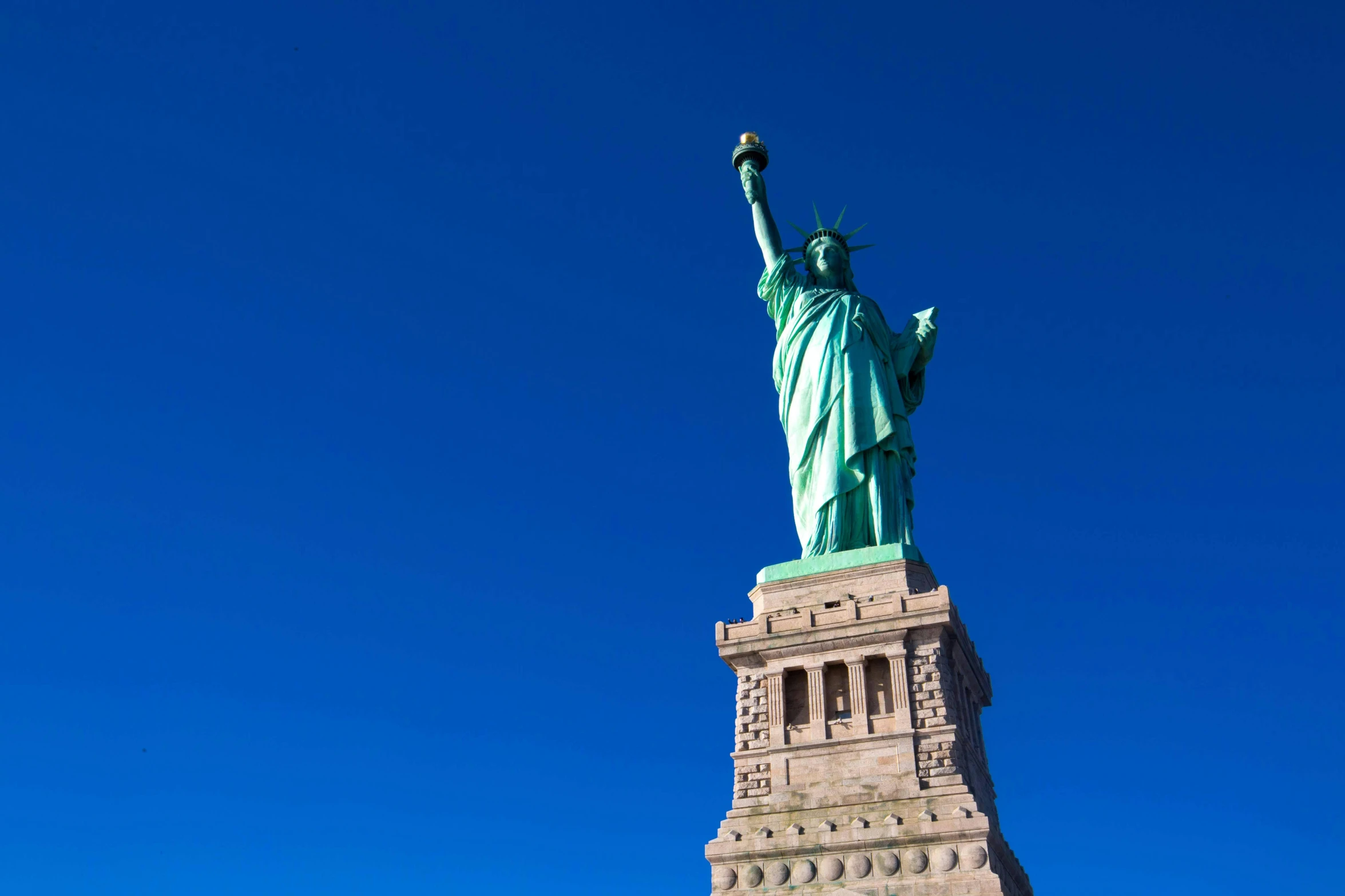 a statue of liberty on top of a very tall building