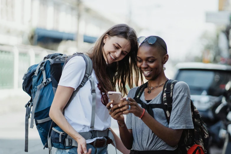 two female s looking at their cell phones