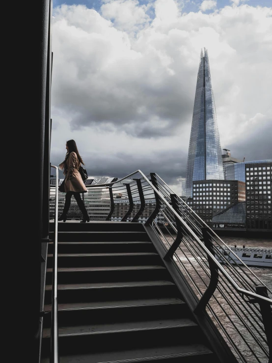 a woman walking down a stairway in a city