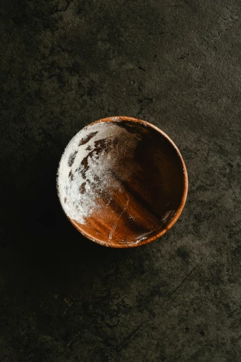 wooden bowl sitting on black surface with no handle