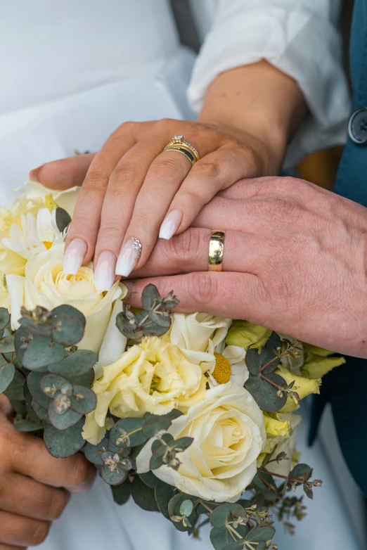 an older couple holding their wedding bouquet