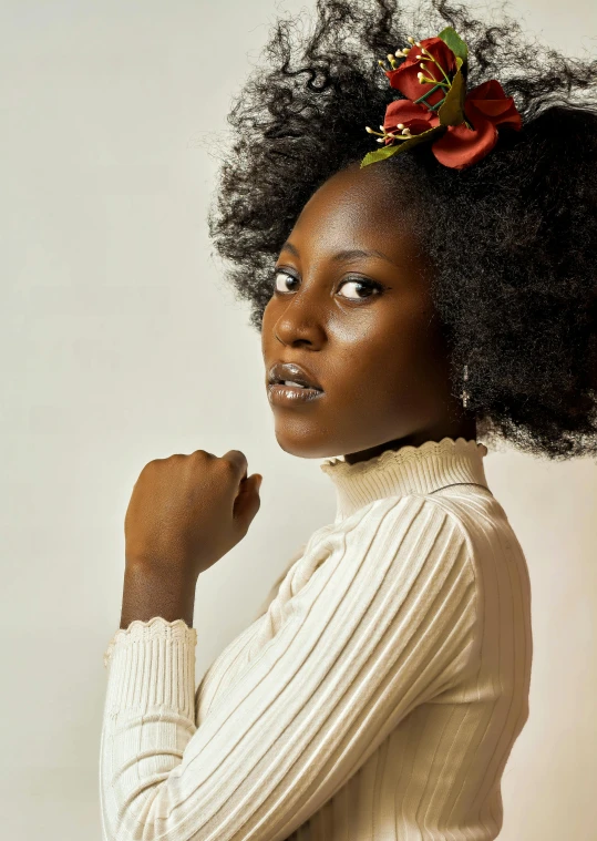 a woman with an afro hairstyle is posing