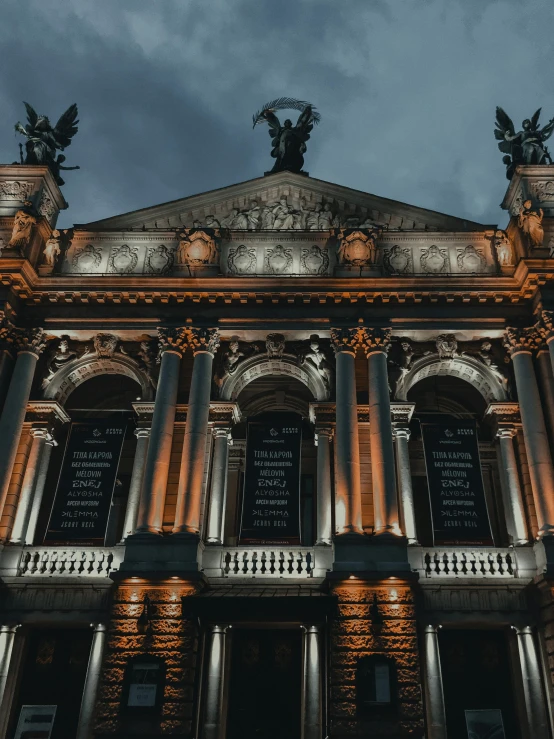 the facade of an ornate building at night